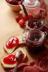 Still life with fresh strawberry in a bowl, strawberry jam and bread for breakfast