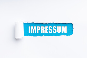 torn paper revealing the word impressum - obrazy, fototapety, plakaty