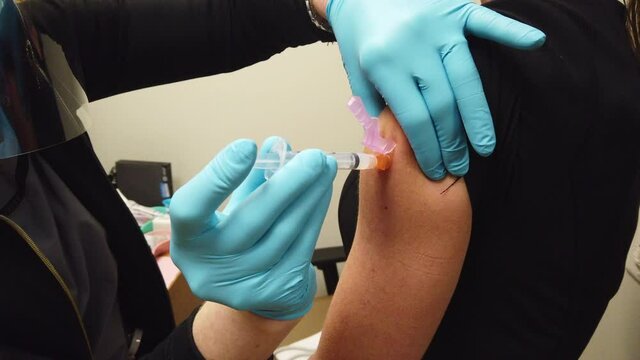 COVID-19 Vaccine Shot Given To An Adult Female Patient