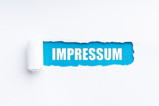 torn paper revealing the word impressum