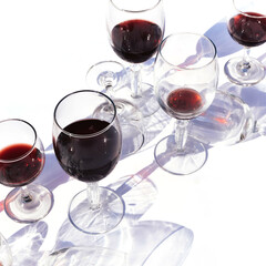 Wine of different varieties in glasses on a white background.