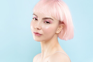 Young modern blond girl with healthy glowing skin and pink hair, fresh natural make up. Female...
