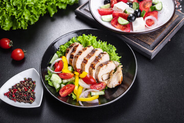 salad grilled chicken breast vegetables tomato, cucumber, onion, pepper outdoor meal snack on the table copy space food background rustic. top view keto or paleo diet