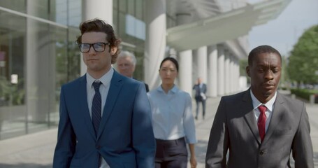 Waist up portrait of diverse business people walk outside office building