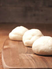 Fototapeta na wymiar Yeast dough balls on a cutting board in a kitchen