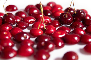 Red ripe sweet cherry lying on a tray with water. 