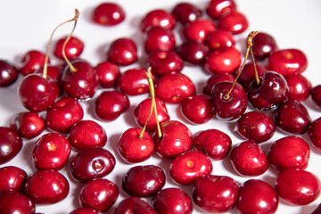 Red ripe sweet cherry lying on a tray with water. 
