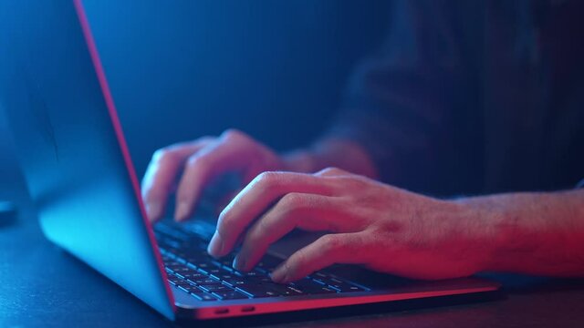 Working On a Laptop Computer Darkness Red and Blue Light