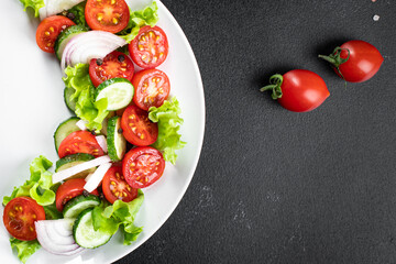 salad fresh vegetables lettuce leaves tomato, cucumber, onion, pepper outdoor meal snack on the table copy space food background rustic. top view keto or paleo diet veggie vegan or vegetarian food