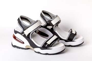 Women's, fashionable, sports sandals on a white background. New youth shoes for girls. Foreground.