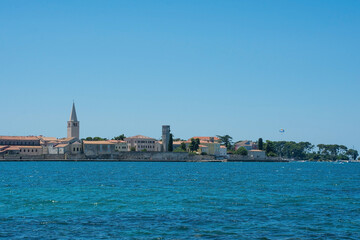 Fototapeta na wymiar The historic medieval coastal town of Porec in Istria, Croatia, seen from the shore just north of the old town 