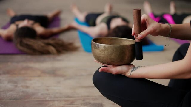 Singing bowls during meditation, lead yoga class outdoors