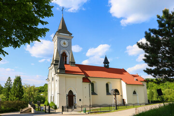 Fototapeta na wymiar STRYSZOW ,POLAND - JUNE 01, 2021: A church with red roof in Stryszow, Poland.