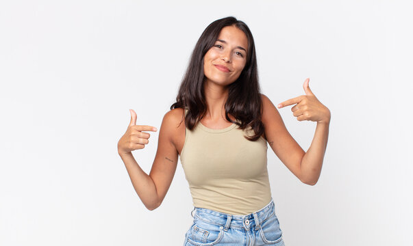 pretty thin hispanic woman looking proud, arrogant and pointing to self