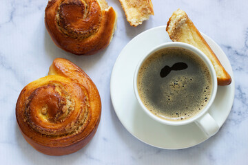 Cinnamon rolls with nut filling, served with coffee.