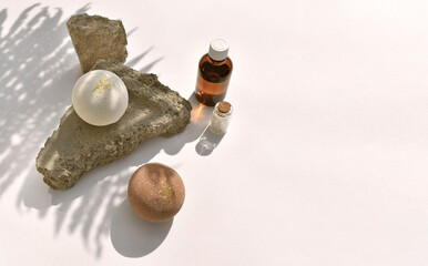 Minimal spa aromatherapy  still life with bath bombs and oil bottle, aroma salt on rock stone...