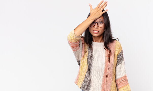 pretty thin hispanic woman raising palm to forehead thinking oops