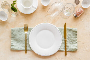 Dinnerware set with view from above - plate with cutlery and napkin