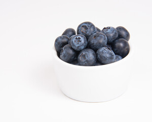 Fresh blueberry in white dish on the white background