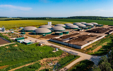 Biogas station at the green large field. Distillation process is used to produce bio gas at...