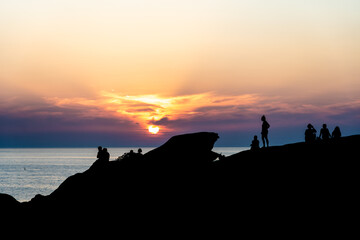 Silhouettes of people at sunset