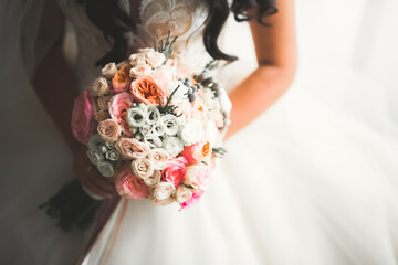 Portrait of stunning bride with long hair posing with great bouquet