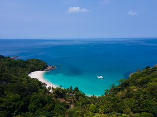 Obraz premium Aerial view top-down of Drone camera over white beach sand and sew water clear. Nature video view of beautiful tropical beach and sea in sunny day. Palm tree at beach. At Phuket, Thailand.