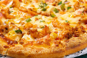 angle view fresh pizza with shrimps and bacon toppings close up