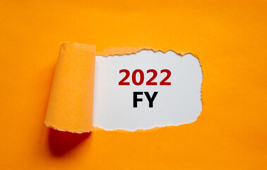 2022 FY fiscal new year symbol. Words '2022 FY fiscal year' appearing behind torn orange paper. Beautiful orange background. Business, 2022 FY fiscal new year concept, copy space.