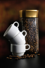 A can of fresh coffee and white coffee cups on a black background