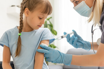 The doctor makes a child vaccination