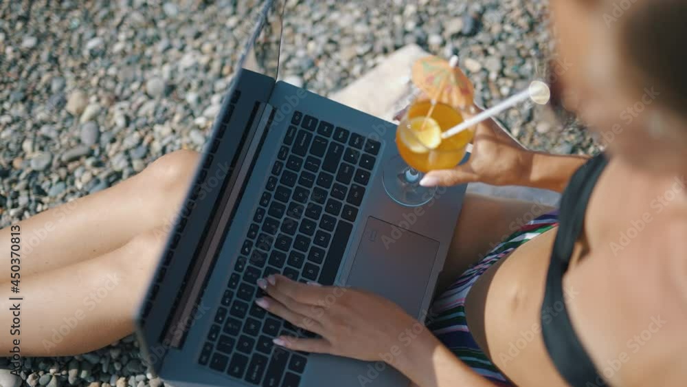 Poster a female freelancer is working on laptop near sea. programmer is coding and surfing on notebook. rem