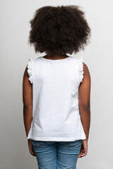 Back view of the multiracial girl wearing white T shirt. Childhood concept. Isolated on white background, studio shot