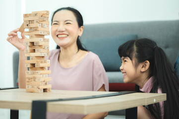 children development education, mother and daughter family playing and learning fun at home, young...