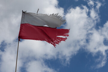 The Polish flag in the sky, the flag of old Poland, the Polish flag in the wind. Destroyed