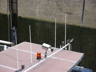Roof of the wheelhouse of an inland cargo ship in the lock chamber in the lower position. You can...
