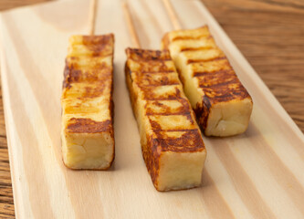 Grilled Rennet or Coalho cheese on a wooden board