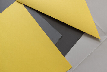 pale yellow construction paper with various shades of gray paper background