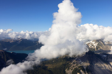 Aerial View from Airplane of Canadian Mountain Landscape. Sunny Summer Clouds. Garibaldi between...