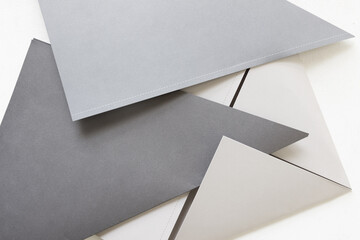 various gray papers folded in half on a light background