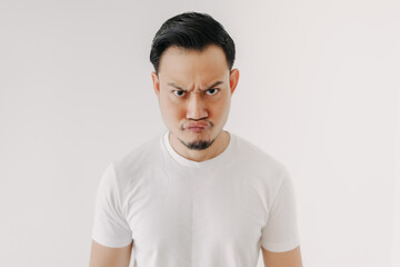 Grumpy face Asian man in white t-shirt isolated on white background.