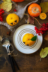 Halloween day decoration party. Halloween wooden table setting with pumpkins and tangerines. Top view flat lay background. Copy space.