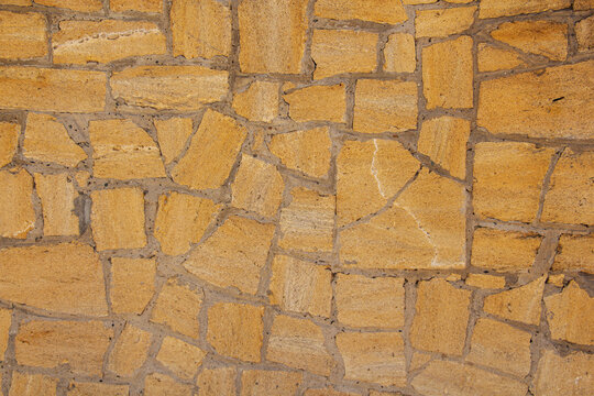 sandstone brick wall, background, close-up. Eco-friendly construction.