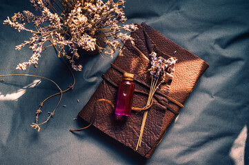 Overhead image of a Love potion, lavender on top of a notebook