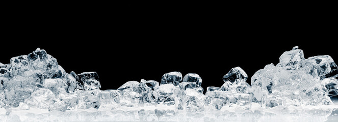 A heap of natural ice cubes on a black background. Purity and freshness concept background.