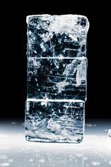 A stack of natural rectangular ice blocks on a black background.