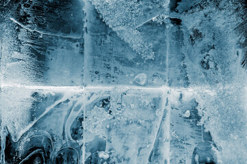 Ice texture background. The textured cold frosty surface of ice block on dark background.