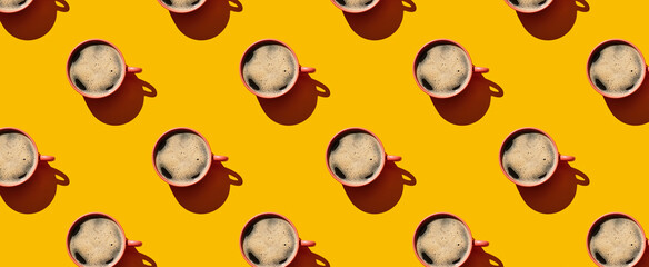 Pattern of coffee mugs on yellow pastel background