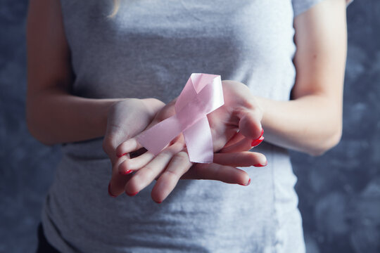 Young Girl Holding Pink Ribbon