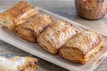 Potato Burekas on wooden background. Israeli Savory Potato Pastries.